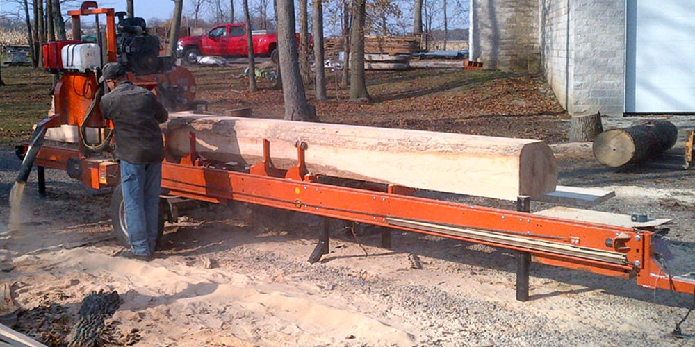 Portable sawmill cutting a log